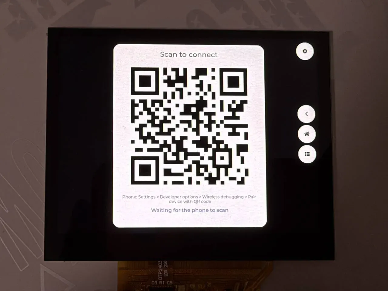 The pairing QR code screen, with the three navigation keys on the right and the settings key in the top right corner