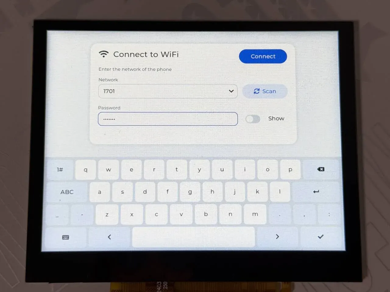 The WiFi settings form: network dropdown, Scan button, password field and on-screen keyboard