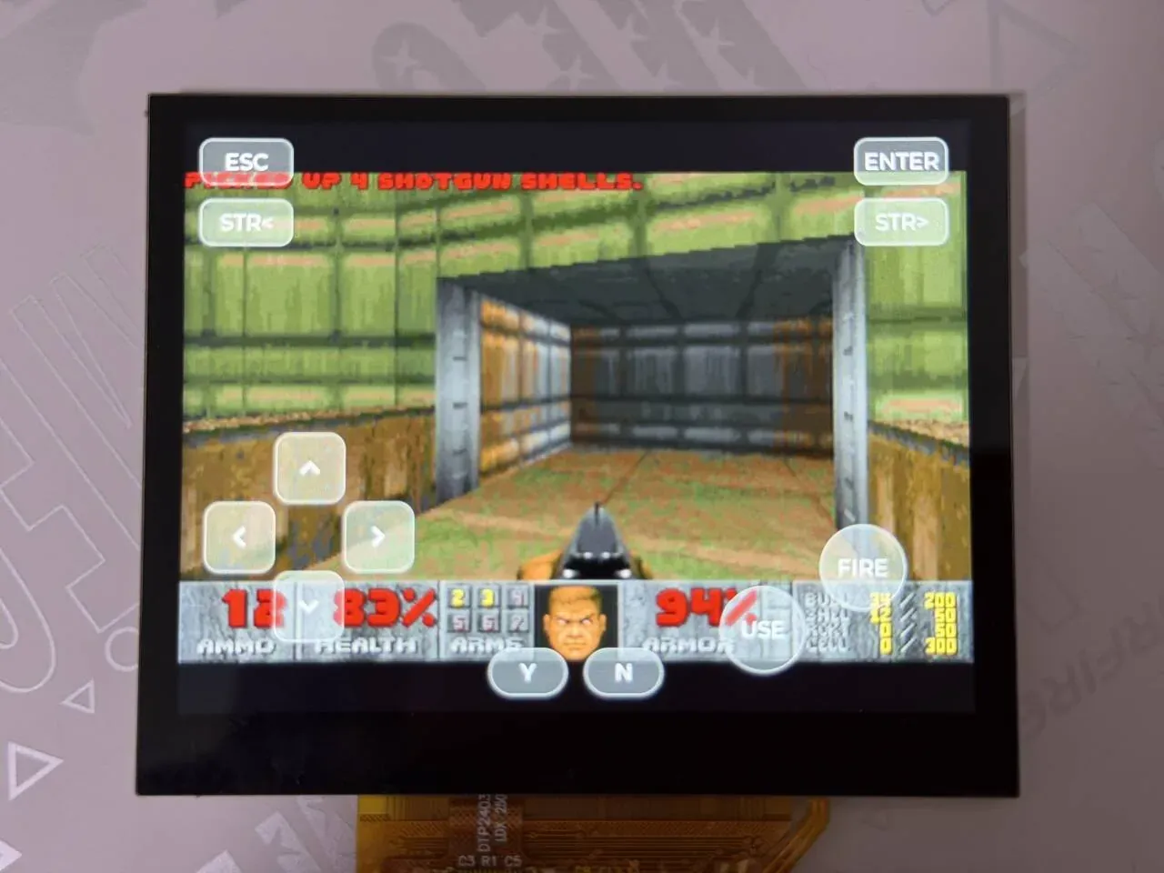 The Doom game picture on the board screen with the on-screen buttons overlaid