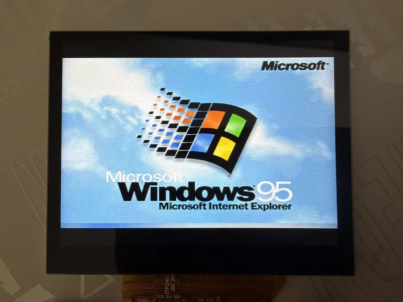 The Windows 95 boot screen on the board's screen